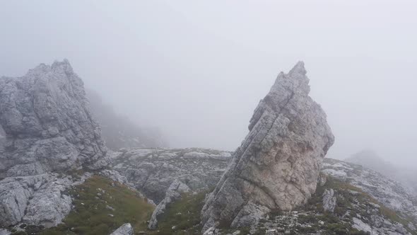 Fly in the fog above rocks