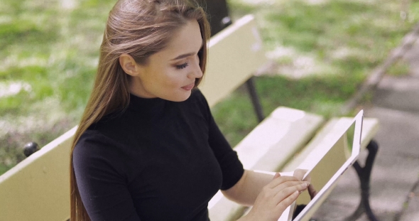Beautiful Girl Browsing Tablet