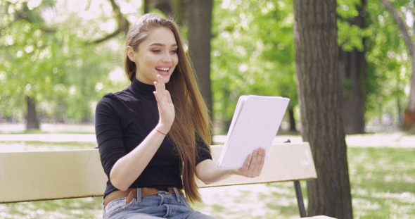 Smiling Woman Using Tablet