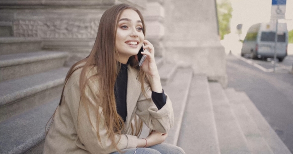 Cheerful Girl Talking Phone Outside