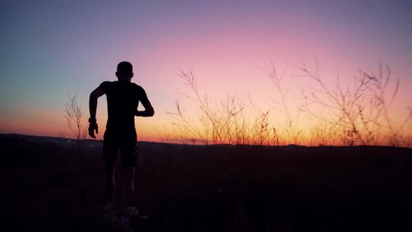 Running Silhouette Training.Marathon Or Triathlon Runner Workout At Dusk.Running In Trail At Sunset