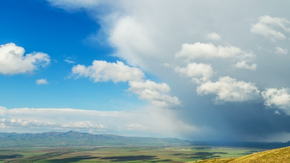 TimeLaps. Lush Clouds Move Rapidly Over the Spring Fields and Villages, the Top View in Spring