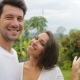 Couple Take Selfie Photo Embracing Outdoors Over Tropical Forest, Young Man And Woman Happy Smiling - VideoHive Item for Sale