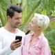 Couple Use Cell Smart Phone Embracing Talking Over Palm Trees, Young Man And Woman Chatting Online - VideoHive Item for Sale