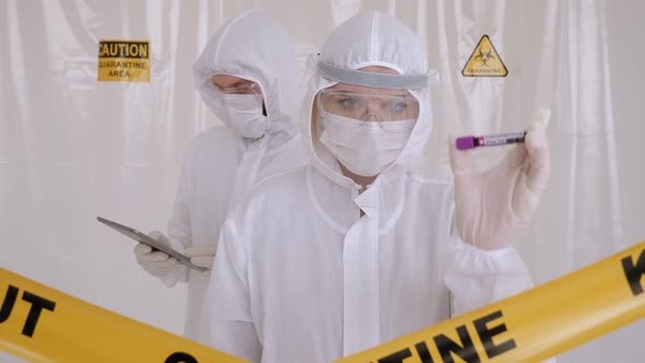 Doctors in the Protective Suits and Masks Looking for a Cure for the Coronavirus