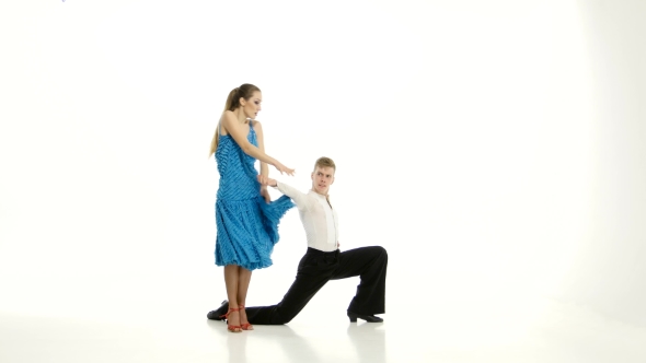 Pair of Graceful Dancers Perform Tango on White Studio Background