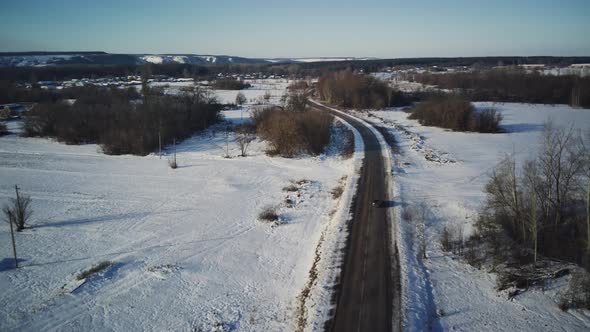 Aerial View of Car Moving on Road in Winter Season