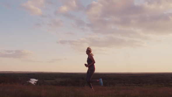 Young Woman Jogging in a Scenic Spot at Sunset