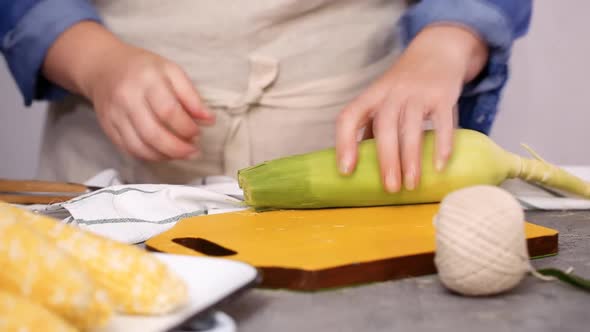 Step by step. Shucking organic corn to make Mexican corn on the cob Elote.