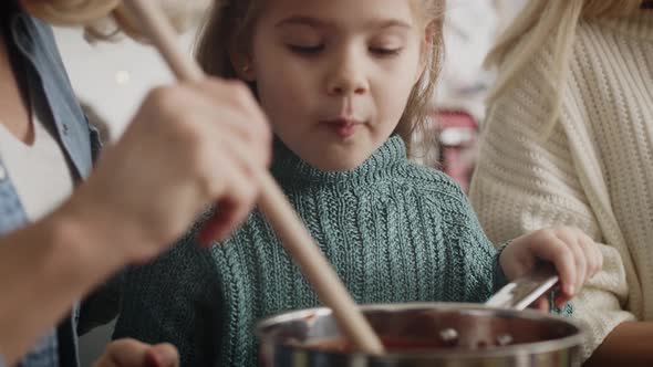 Close up video of little cute girl cooking in the kitchen. Shot with RED helium camera in 8K.