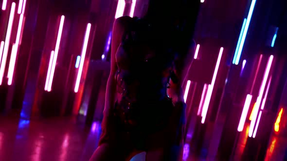 Close-up of a Brunette Woman's Body Passionately Posing Against Walls with Colorful Neon Lights on