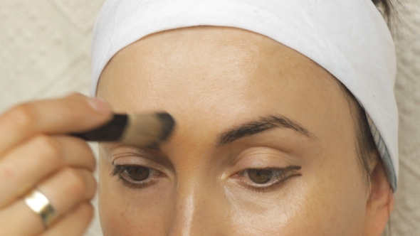 Young Woman Applying Makeup at Home