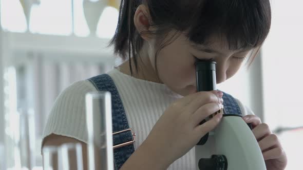 Girl looking microscope