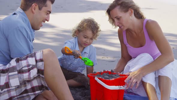 Family at beach making sandcastle together, Costa Rica.  Shot on RED EPIC for high quality 4K, UHD, 
