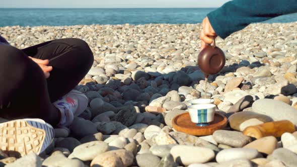 The process of brewing tea. Chinese ceremony on a pebble beach.