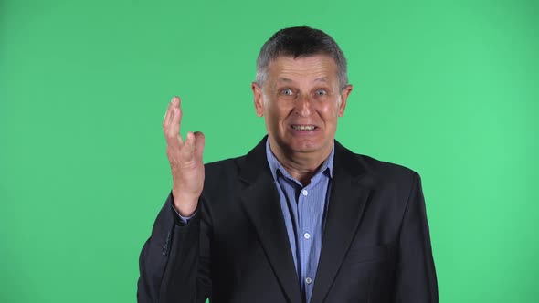 Portrait of Aged Man Showing Gesture Come Here, Isolated Over Green Background.