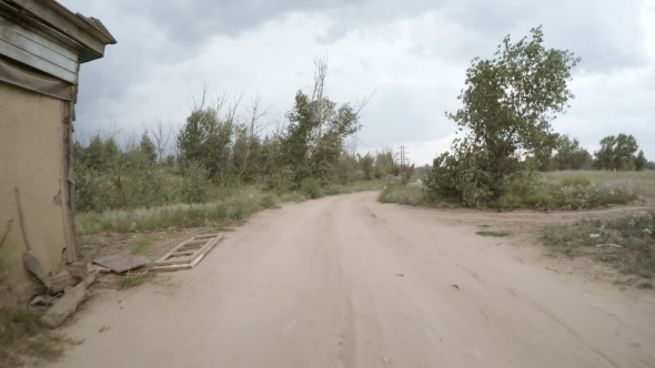 Car Driving Along a Rural Dirt Road
