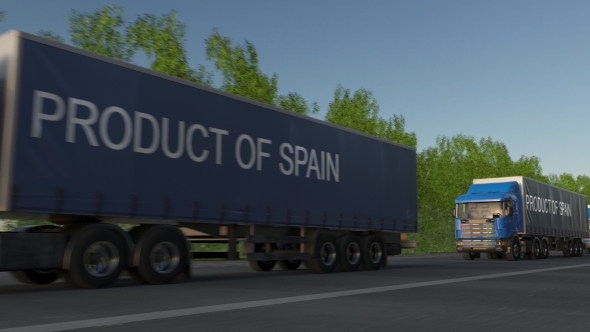 Moving Freight Semi Trucks with PRODUCT OF SPAIN Caption on the Trailer