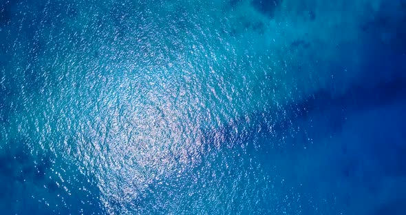 Tropical aerial copy space shot of a paradise sunny white sand beach and turquoise sea background