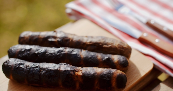 Three Charred Sausages Outside