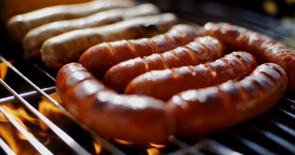 Sausages Grilling Over the Flames