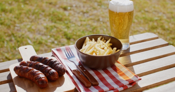 Three Tasty Smoked Grilled Sausages with Chips