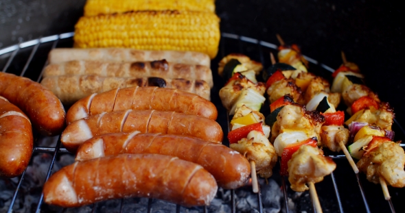 Sausages and Vegetables Cooking on Grill