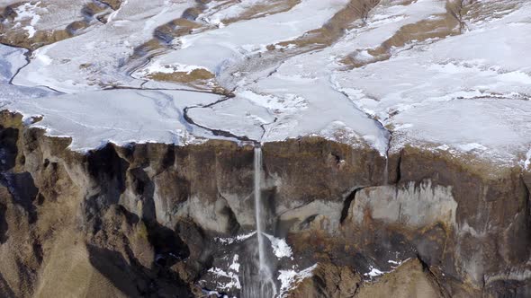 Small and Beautiful Waterfall on a Snowcapped Mountain in the Winter