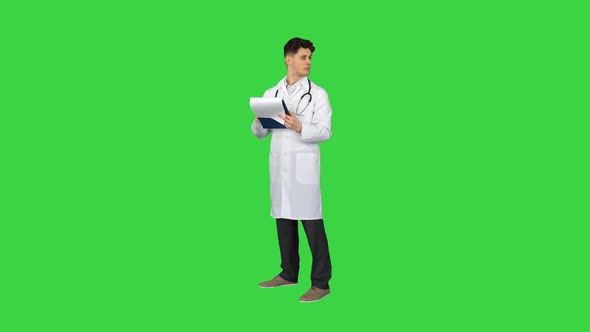 Great Results Doctor Dancing Afler Looking Through Documents on a Green Screen, Chroma Key.