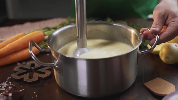 The Cook Uses Hand Blender To Make Mashed Soup in the Metal Pan, Cooking Healthy Food, Mashed