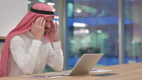 Stressed Arab Businessman with Laptop Having Headache