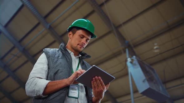 Supervisor Manager Holding Tablet Computer in Modern Agricultural Facility Alone