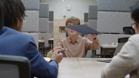 Female Employee Having Meeting with Managers