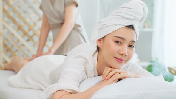 Asian young happy woman feeling relax during shoulder and back massage.