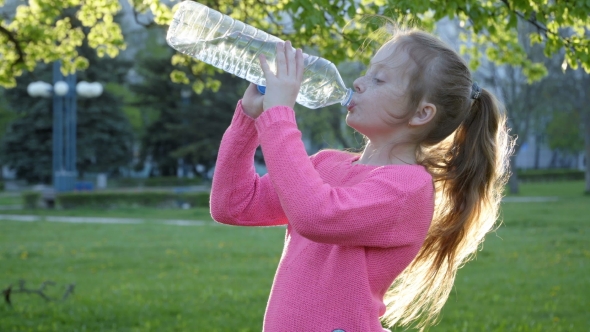 Girl Is Drinking Water From the Bottle