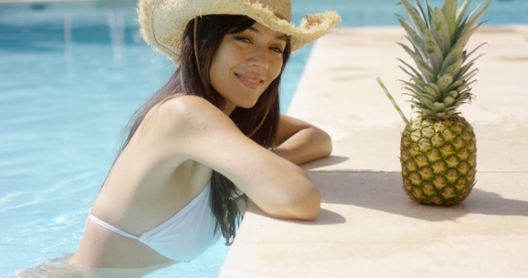 Pretty Trendy Young Woman in a Summer Pool