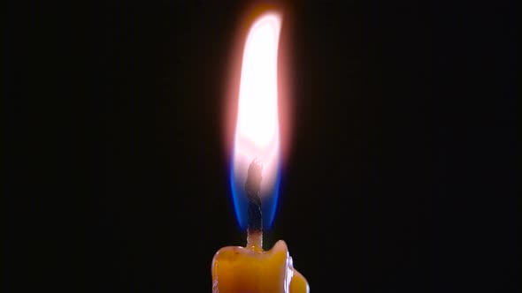 Candle Is on and Goes Out. Black Background. Close Up