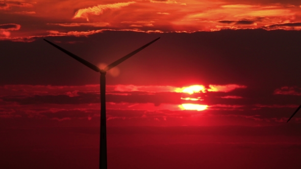 3 Wind Mills Against Red Sunset