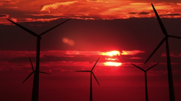 A Lot of Wind Mills Against Red Sunset alt