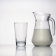 Jug of Milk and an Empty Transparent Glass Standing on White Surface - VideoHive Item for Sale
