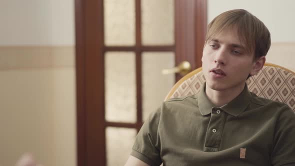 Handsome Young Man at a Reception at the Psychologist