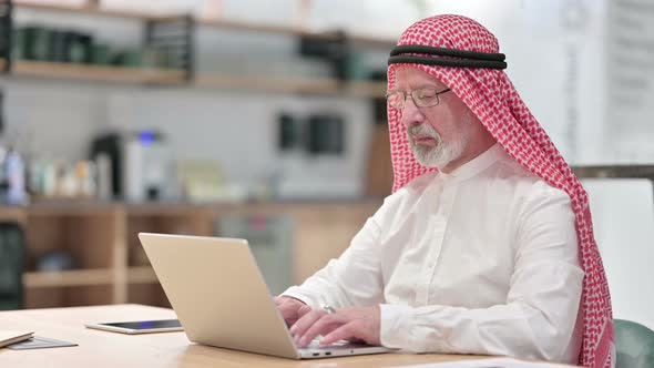 Senior Old Arab Businessman Working on Laptop