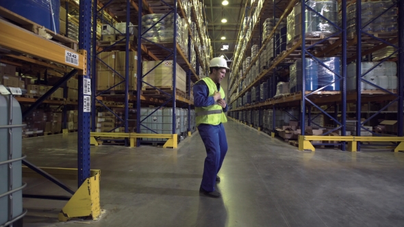 Worker Dancing Between Racks in Warehouse
