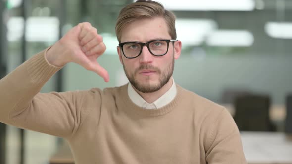 Thumbs Down Gesture By Young Creative Man