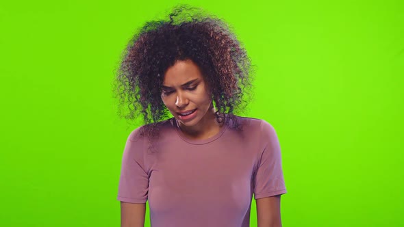 African Woman Keeps Palm on Forehead, Regrets Did Something Wrong on Chroma Key