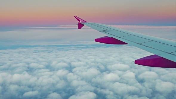 Aircraft Wing on Cloudscape and Blue Sky