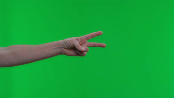 Female Hand Shows Two Fingers on Isolated Green Background
