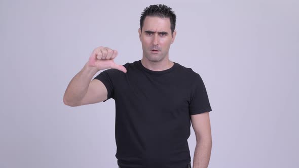 Angry Man Looking Upset and Giving Thumbs Down