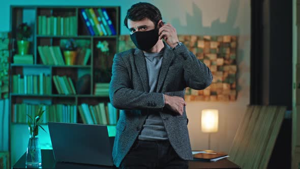 Office Worker with a Protective Mask at His Work