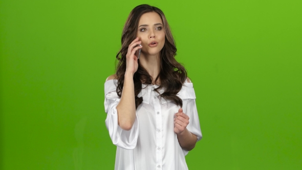 Brunette Girl Swears on the Phone and Screams. Green Screen